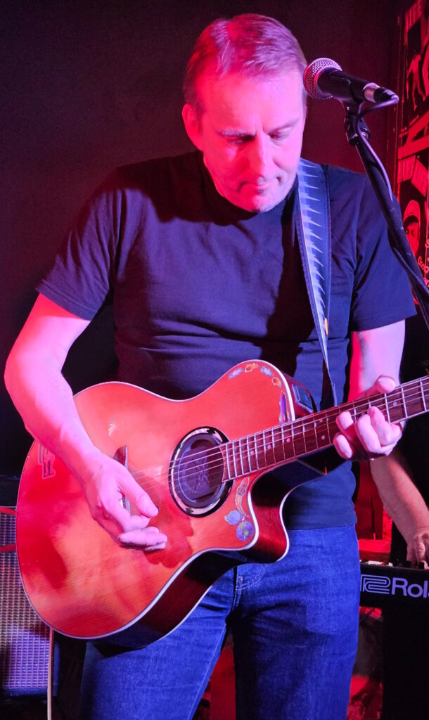 Jim playing his acoustic guitar
